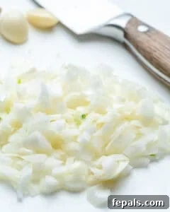 Chopped onions on a cutting board.