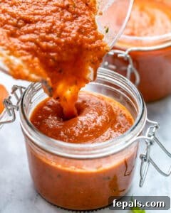 Marinara sauce being poured in jar