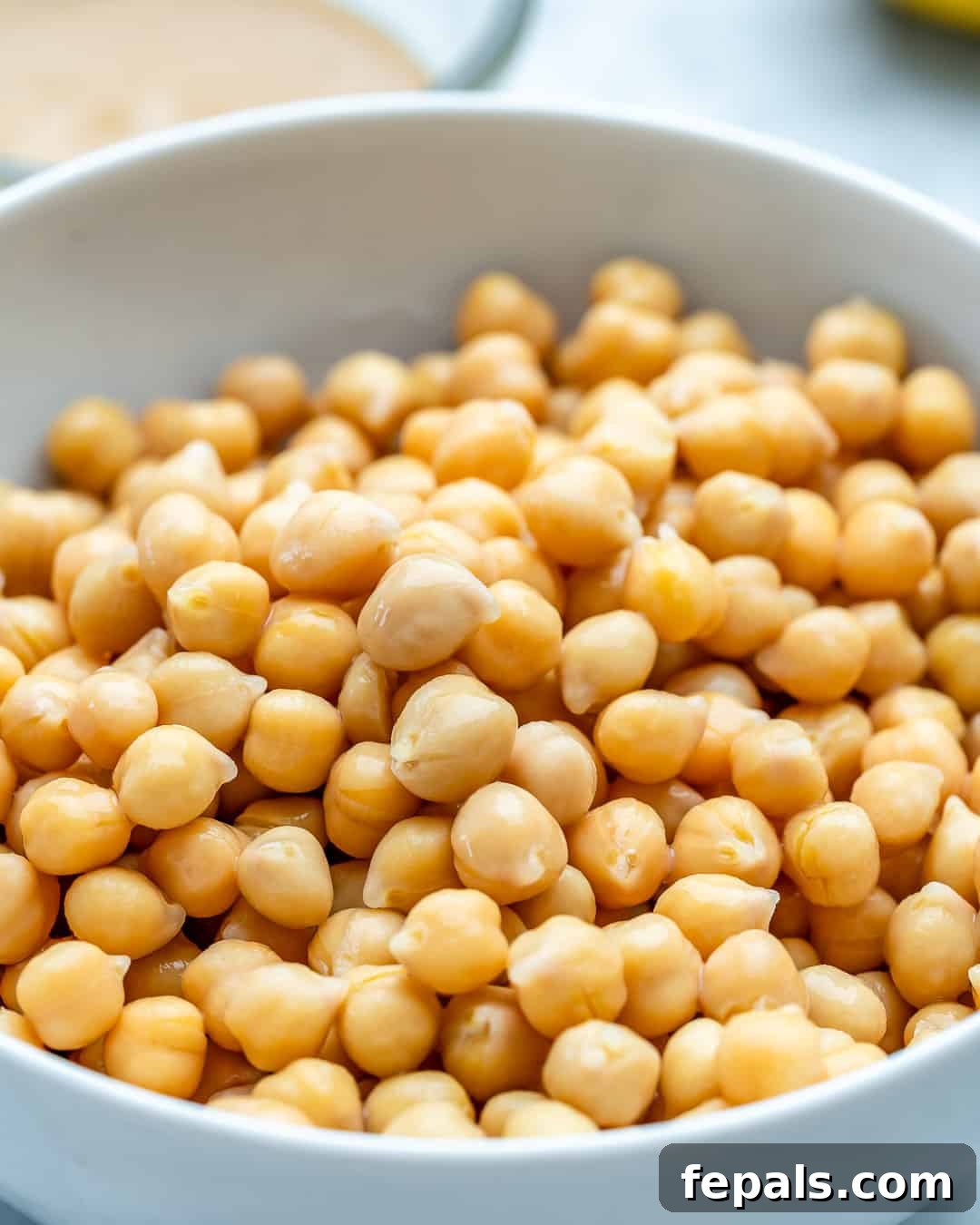 Simple Steps to Creamy Homemade Hummus 4 Rinsed and drained chickpeas in a colander, ready for blending.