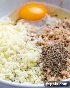 Crispy Cauliflower Pizza Crust 19 Mix cauliflower rice with egg and seasonings in a bowl.