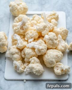 Healthy and Delicious Cauliflower Alfredo Sauce 12 cut up cauliflower on cutting board