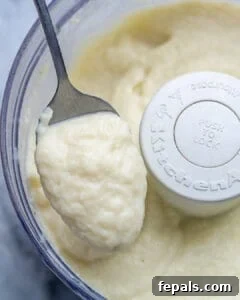 Healthy and Delicious Cauliflower Alfredo Sauce 18 blended cauliflower sauce in food processor with a spoonful of the sauce