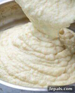 Healthy and Delicious Cauliflower Alfredo Sauce 19 cauliflower sauce being poured in pan
