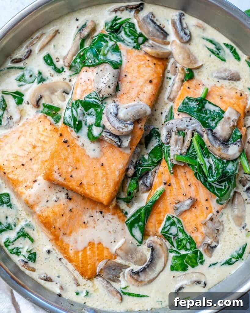 Effortless Salmon Florentine 4 top view or salmon florentine cooked with mushrooms and spinach in a pan