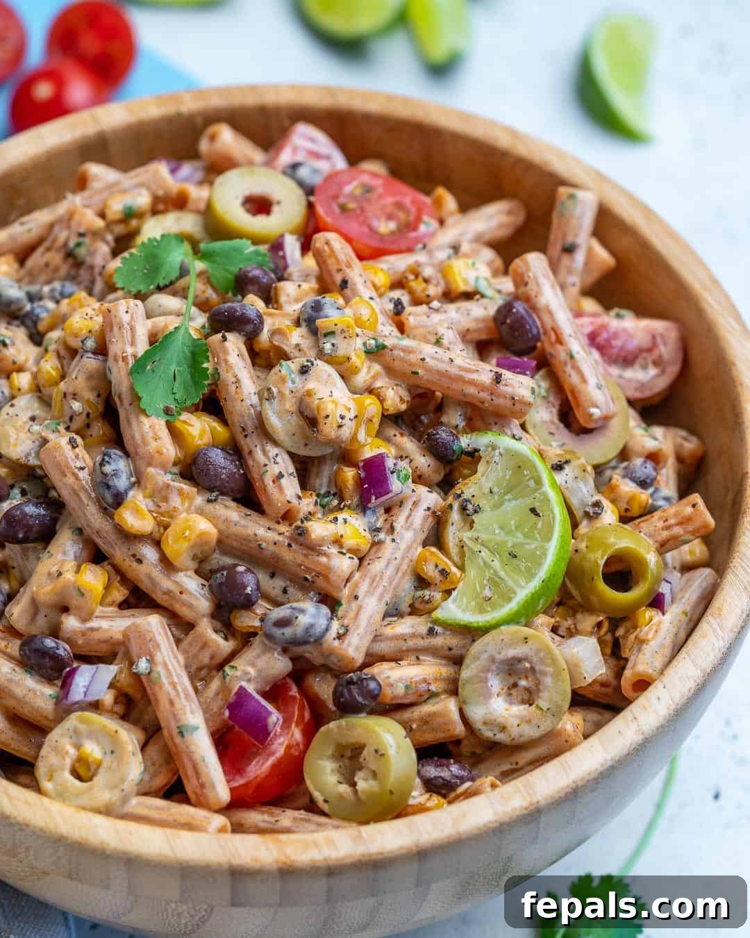 Sun-Kissed Southwest Pasta 6 A side view of the delicious Southwest pasta salad, showcasing its layers of ingredients in a wooden bowl.