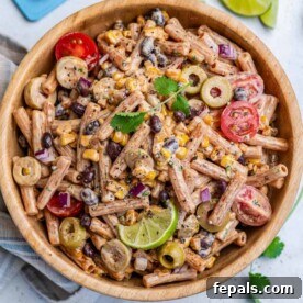Sun-Kissed Southwest Pasta 8 Pasta salad with beans and veggies in a round wooden bowl.