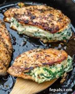 Cheese stuffed chicken breast on a pan.