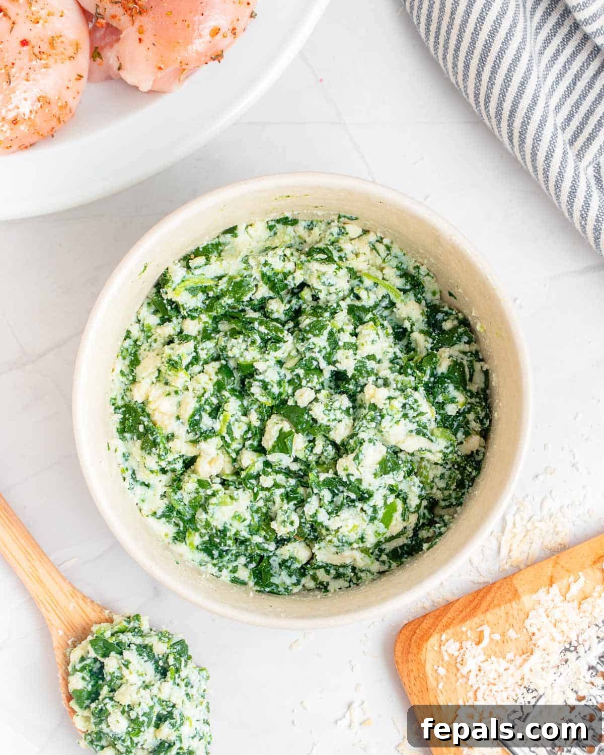 Creamy Spinach and Cheese Stuffed Chicken 6 Creamy cheese and spinach filling mixed in a bowl.