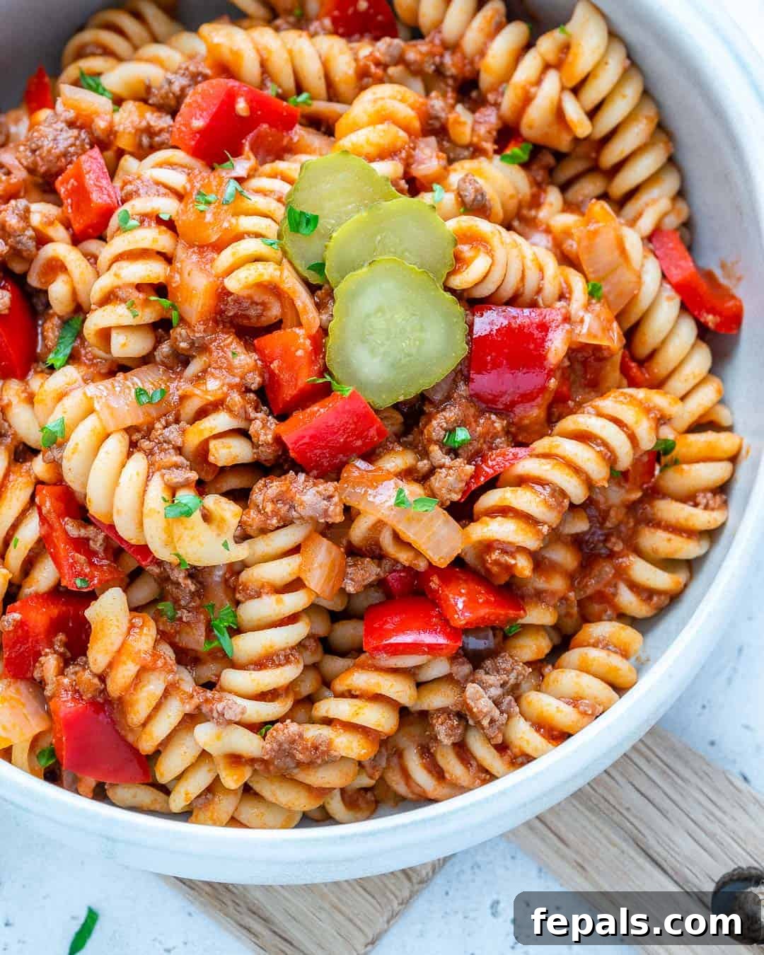 One-Pot Cheeseburger Pasta 5 Close-up view of a bowl of cheesy cheeseburger pasta, highlighting the textures and rich sauce.