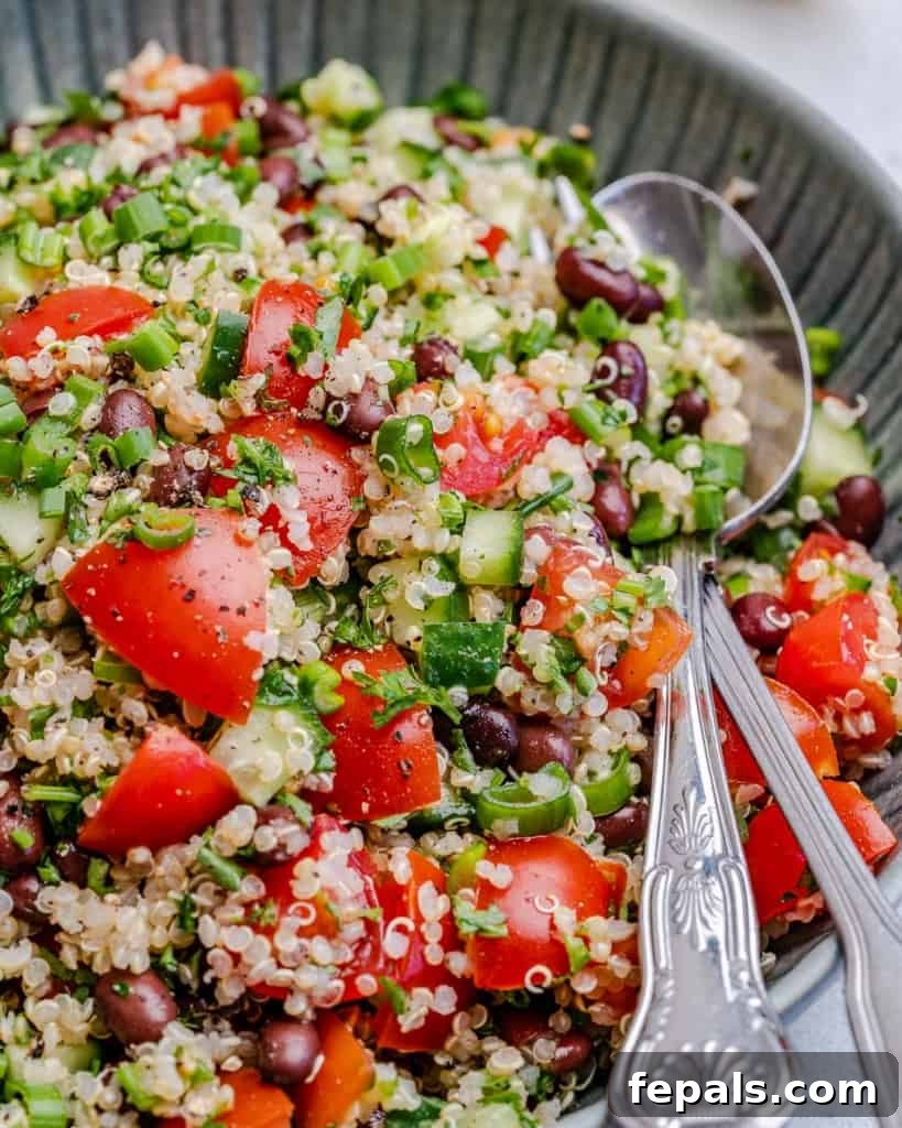 Vibrant Quinoa Black Bean Herb Bowl 10 side view of mixed tabbouleh salad on plate with spoon visible in the tabbouleh