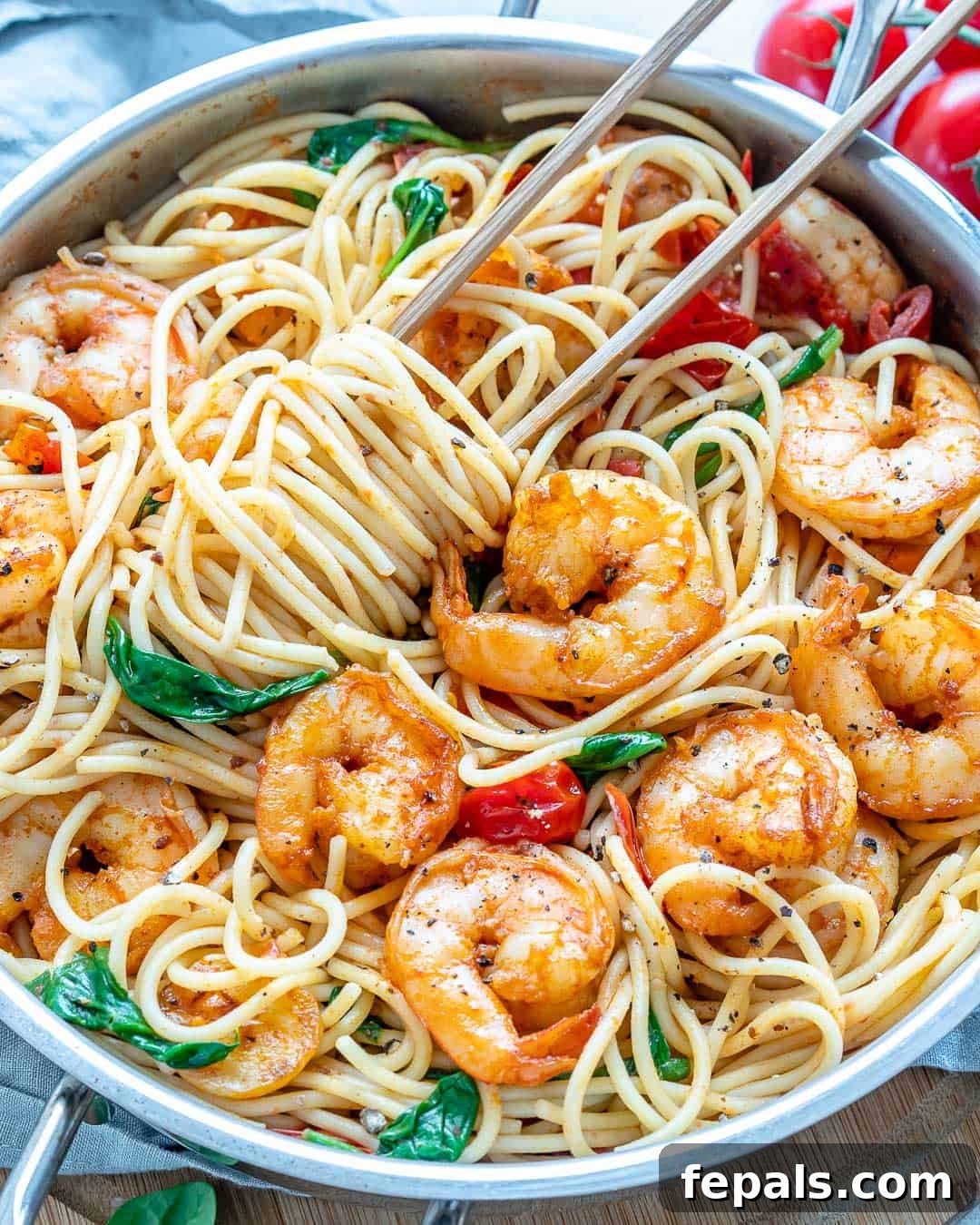A close-up of the delicious Garlic Shrimp Spaghetti, garnished with fresh herbs and a drizzle of olive oil, highlighting its vibrant colors and textures.