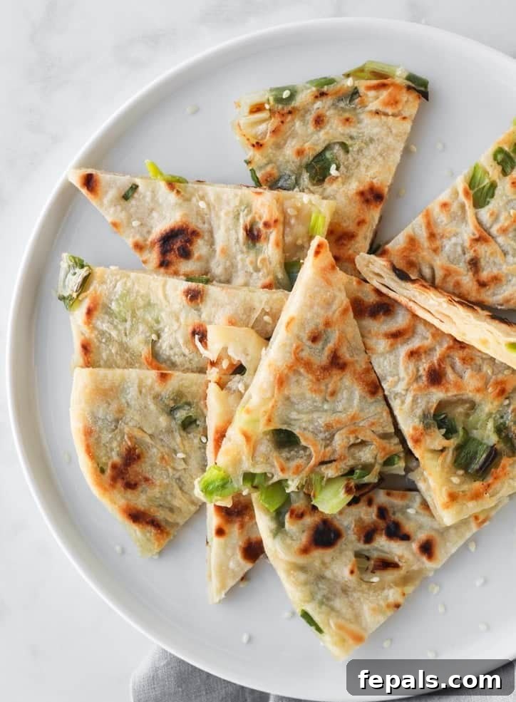 top view of cut up scallion pancakes on a plate