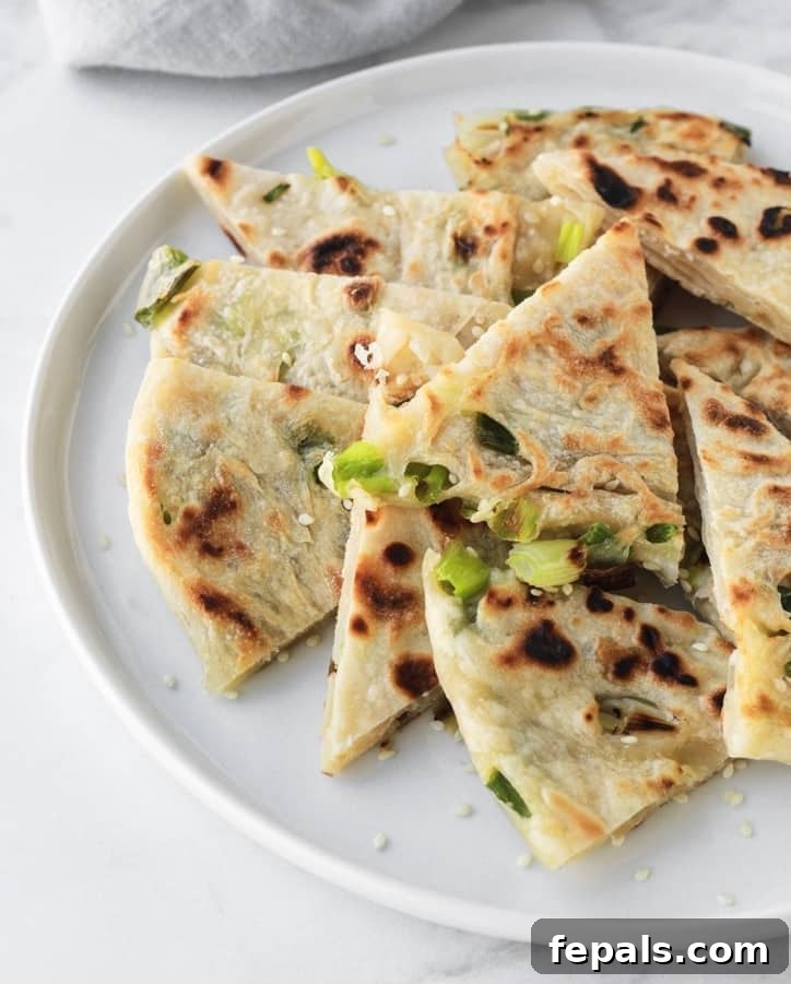 side view of pancake cut up on a white plate