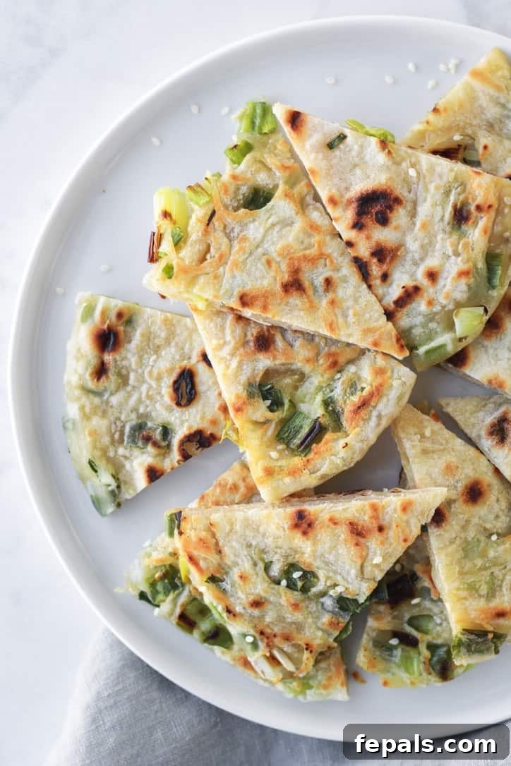 top view of Chinese pancakes cut up on a plate