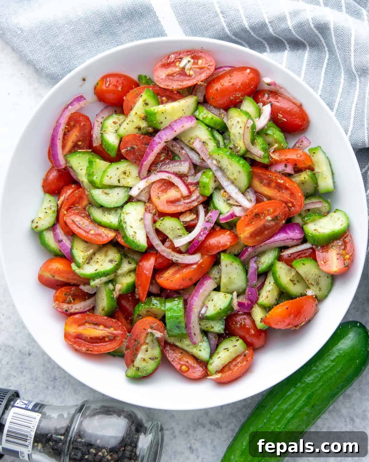 Summer's Delight Salad 5 Close-up top view of a refreshing tomato salad, highlighting the vibrant red and green colors, in a chic white bowl.