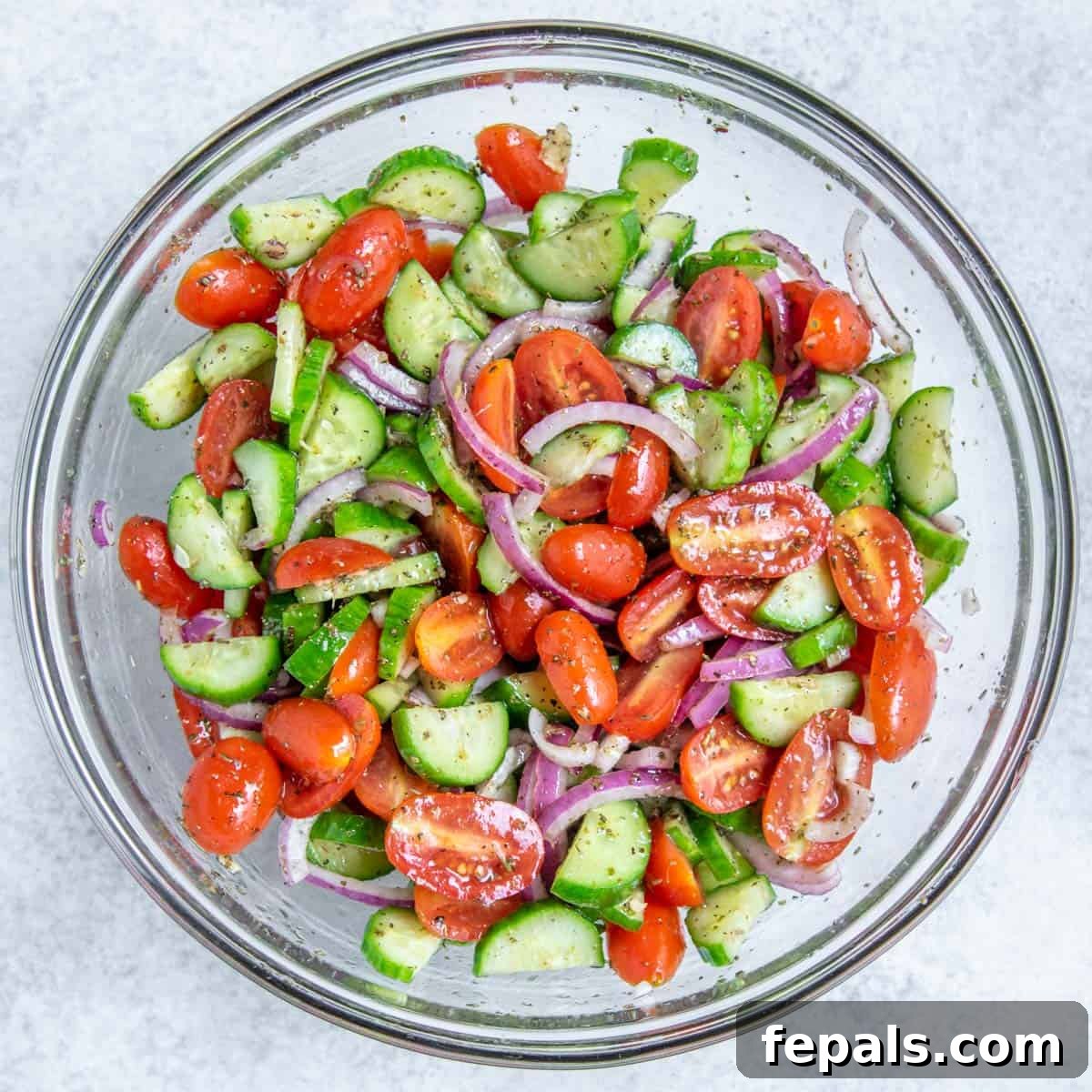 Summer's Delight Salad 7 Top view of the fresh and colorful cucumber and tomato salad elegantly presented in a round white bowl, ready to be enjoyed.