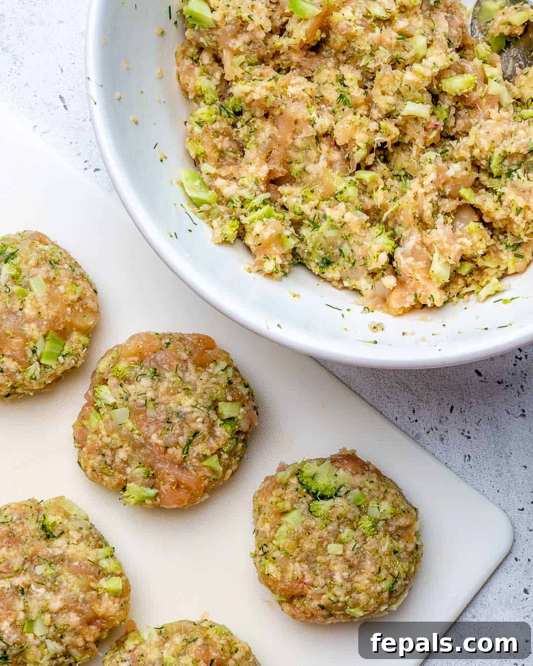 Savory Chicken & Broccoli Bites 3 raw chicken fritters mix in a bowl with raw patties