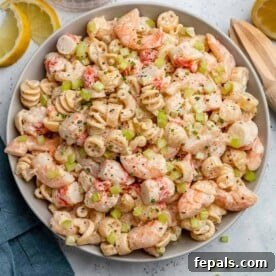 Top view of creamy pasta salad in a white bowl