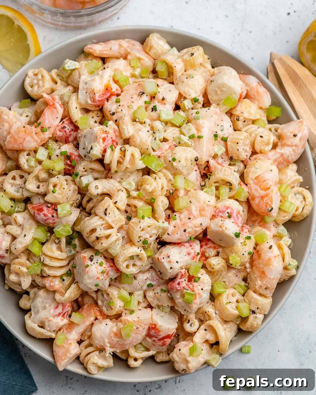 Close-up top view of creamy shrimp pasta salad served in a white bowl