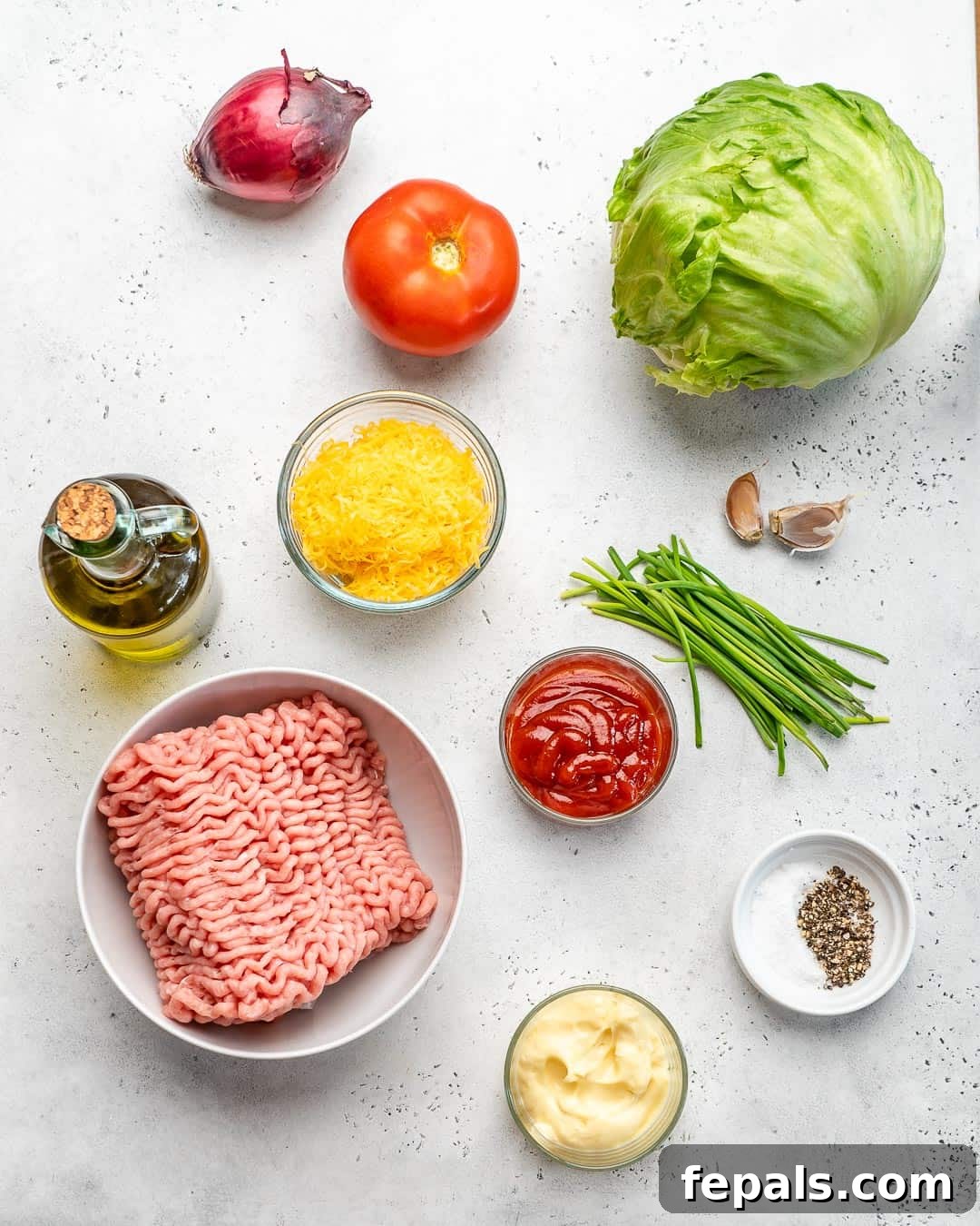 A vibrant display of fresh chicken burger ingredients laid out on a wooden board, including ground chicken, chives, garlic, cheese, and condiments.