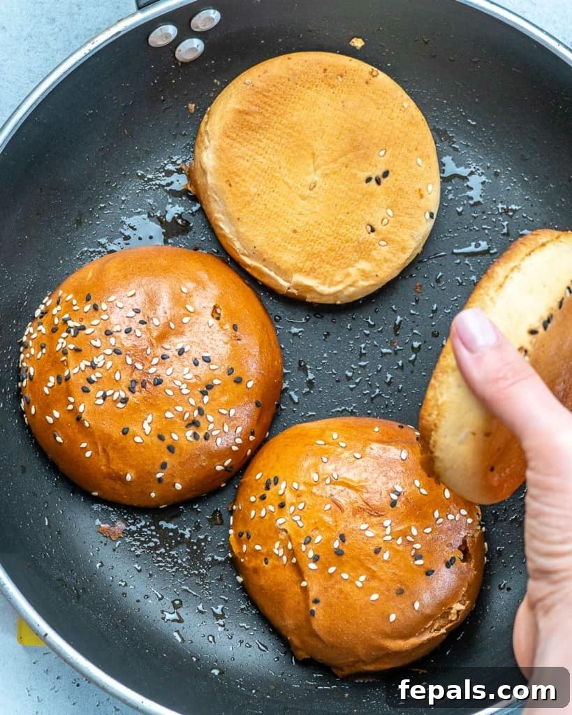 burger buns being cooked over a skillet