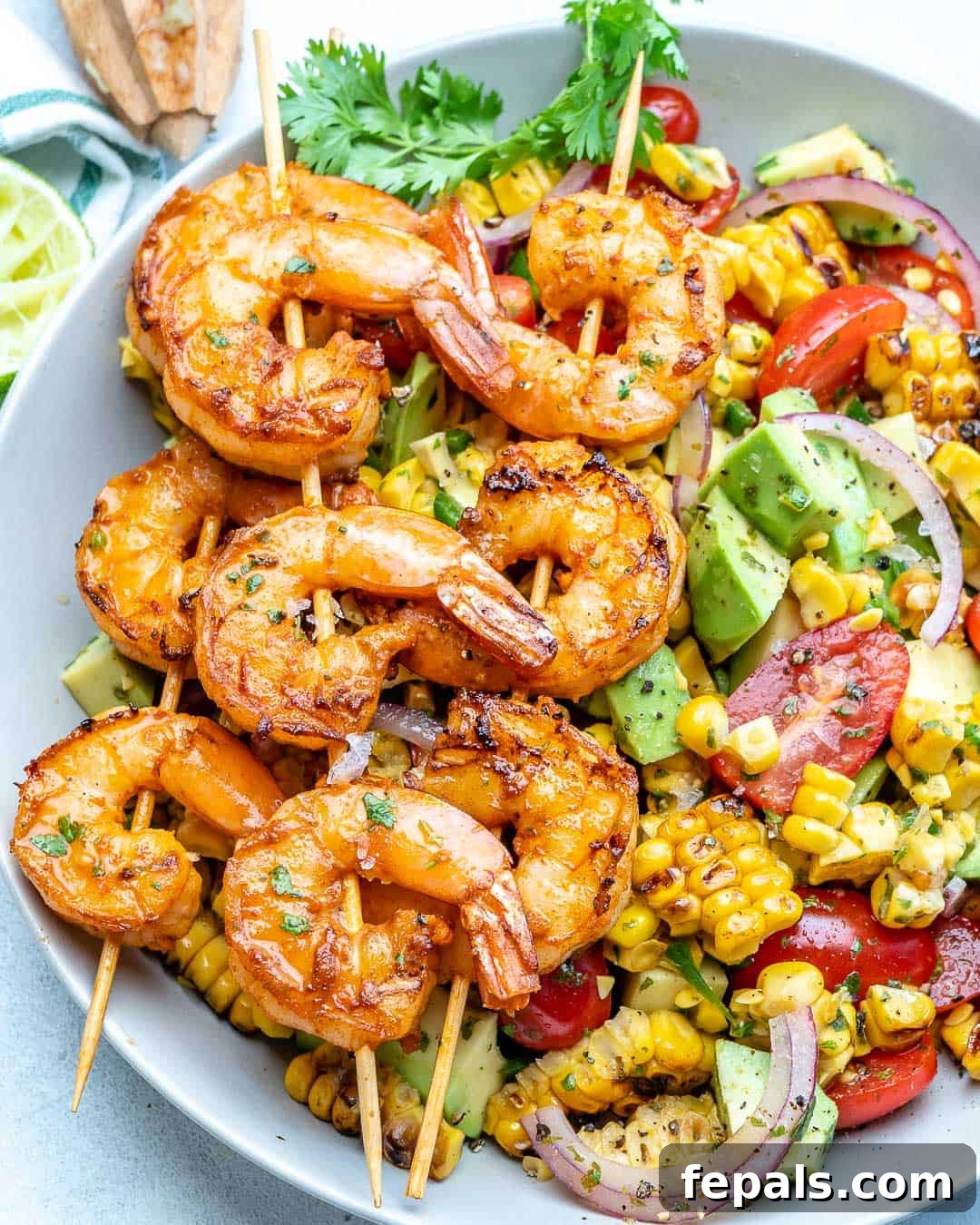 Zesty Shrimp Avocado Corn Salad 3 top view of corn salad with grilled shrimp skewers