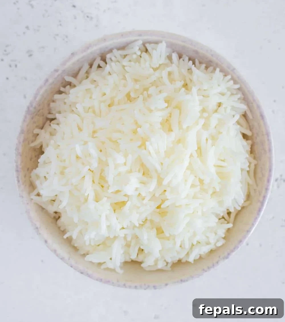 Perfectly Fluffy Rice Every Time 2 Top view of cooked basmati rice in a bowl, showing fluffy, separated grains.