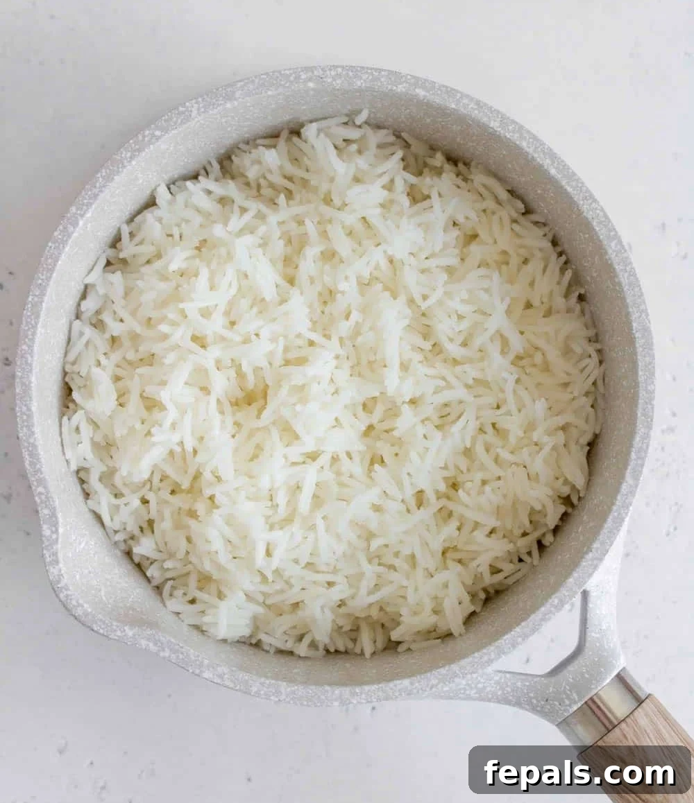 Perfectly Fluffy Rice Every Time 5 Top view of cooked basmati rice in a pot, demonstrating its fluffy texture.