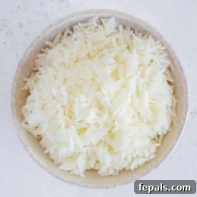 Perfectly Fluffy Rice Every Time 7 Cooked rice in a bowl, top view, showcasing its fluffy texture.