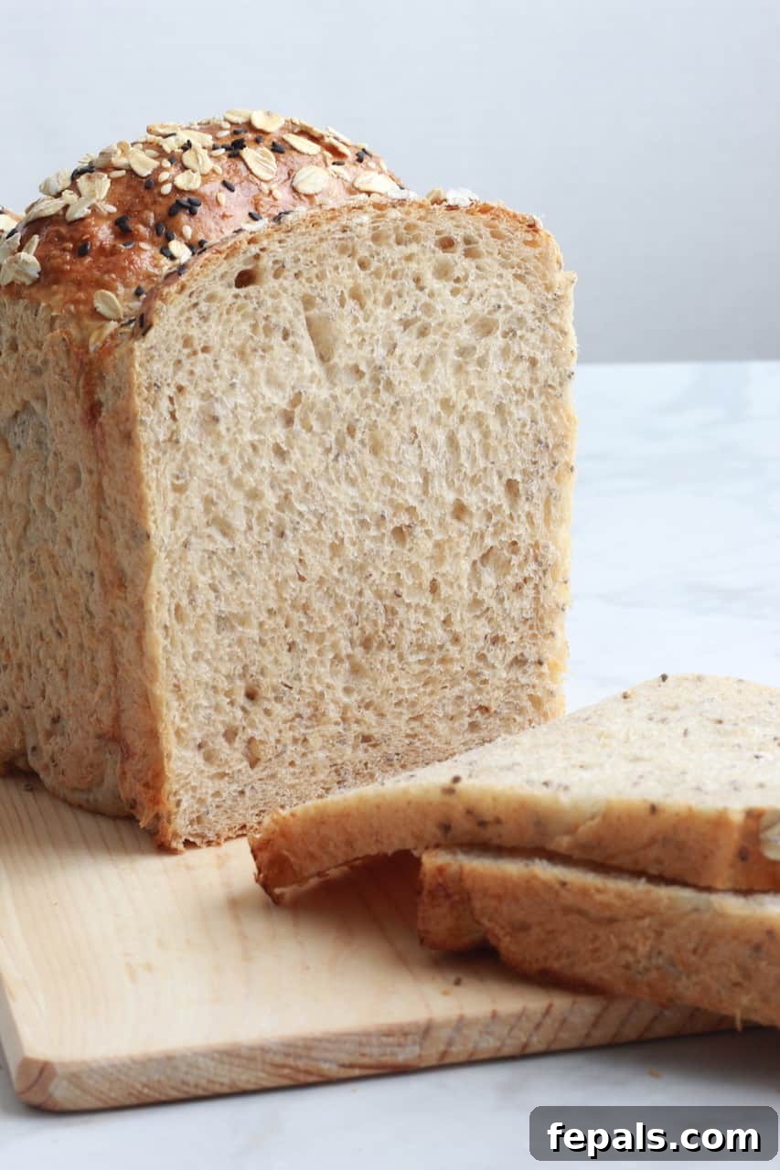 Artisan Whole Wheat Chia Loaf 8 sliced loaf of chia seed bread on a wooden board