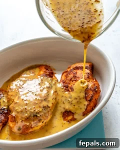 Golden Honey Mustard Chicken 9 honey mustard sauce marinade added over baked chicken breast in a white baking dish