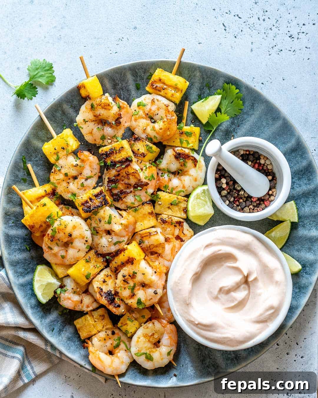 grille shrimp on blue plate with coconut yogurt dip