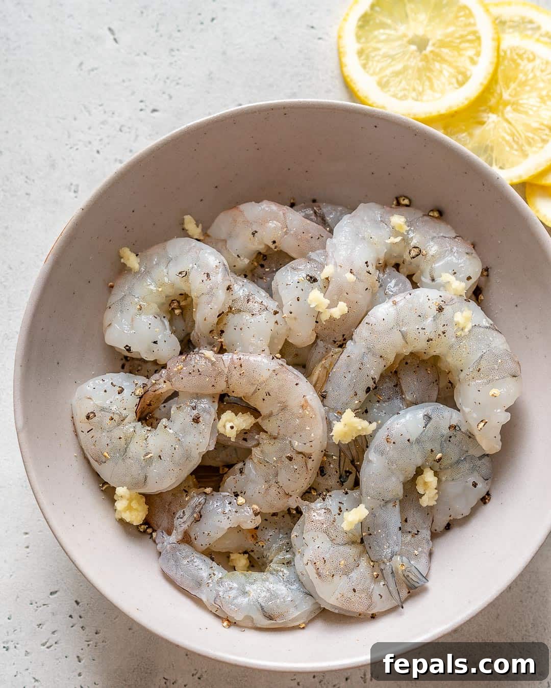 marinated raw shrimp in a bowl with spices