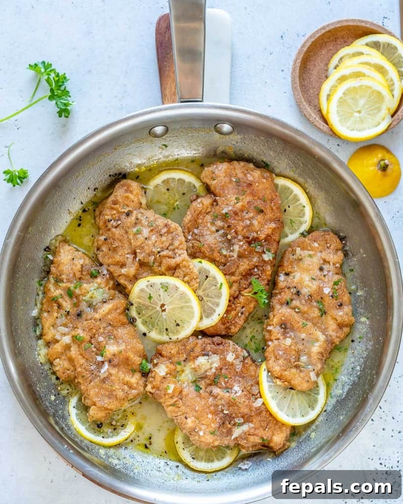 pan with chicken cutlets in a vibrant lemon sauce, ready to serve
