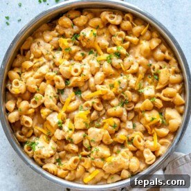 chicken mac and cheese with buffalo sauce in skillet.