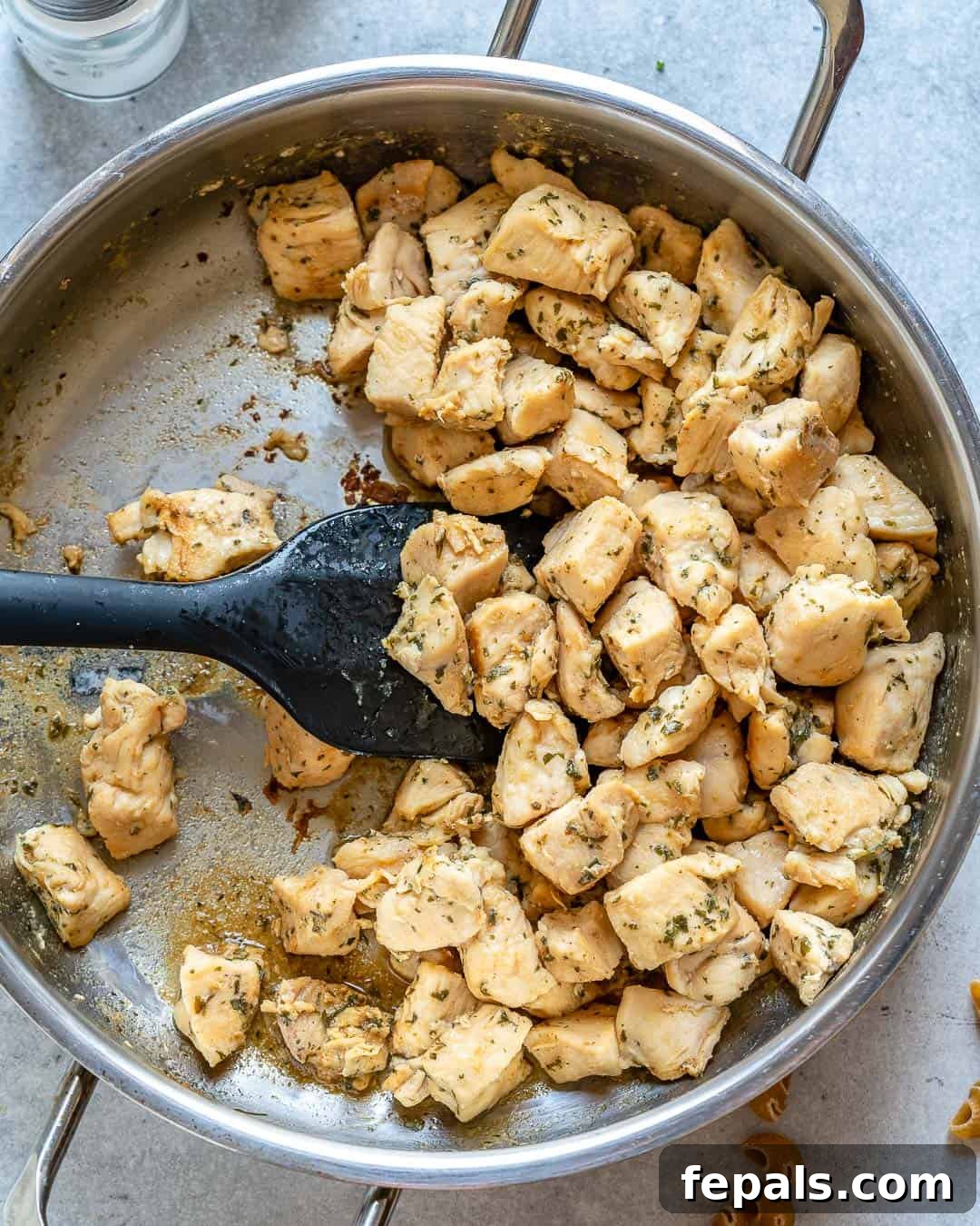 Spicy Buffalo Chicken Macaroni Bake 5 Close-up of perfectly cooked chicken bites in a skillet, seasoned and golden brown.
