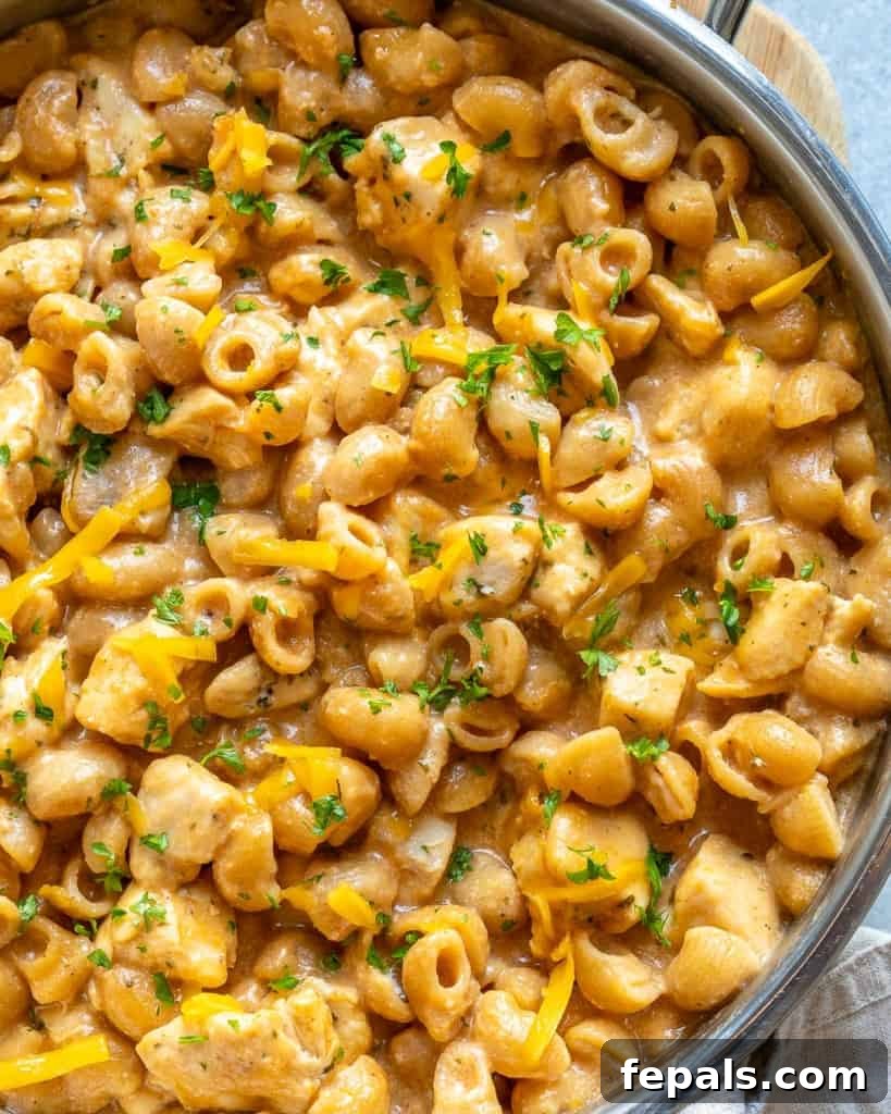 Spicy Buffalo Chicken Macaroni Bake 9 Side view of a skillet filled with buffalo chicken mac and cheese, showing its hearty texture.