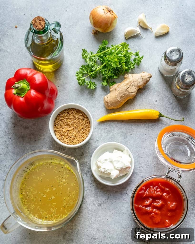 Homestyle Tomato Rice Soup 4 fresh ingredients for homemade tomato rice soup laid out on a cutting board