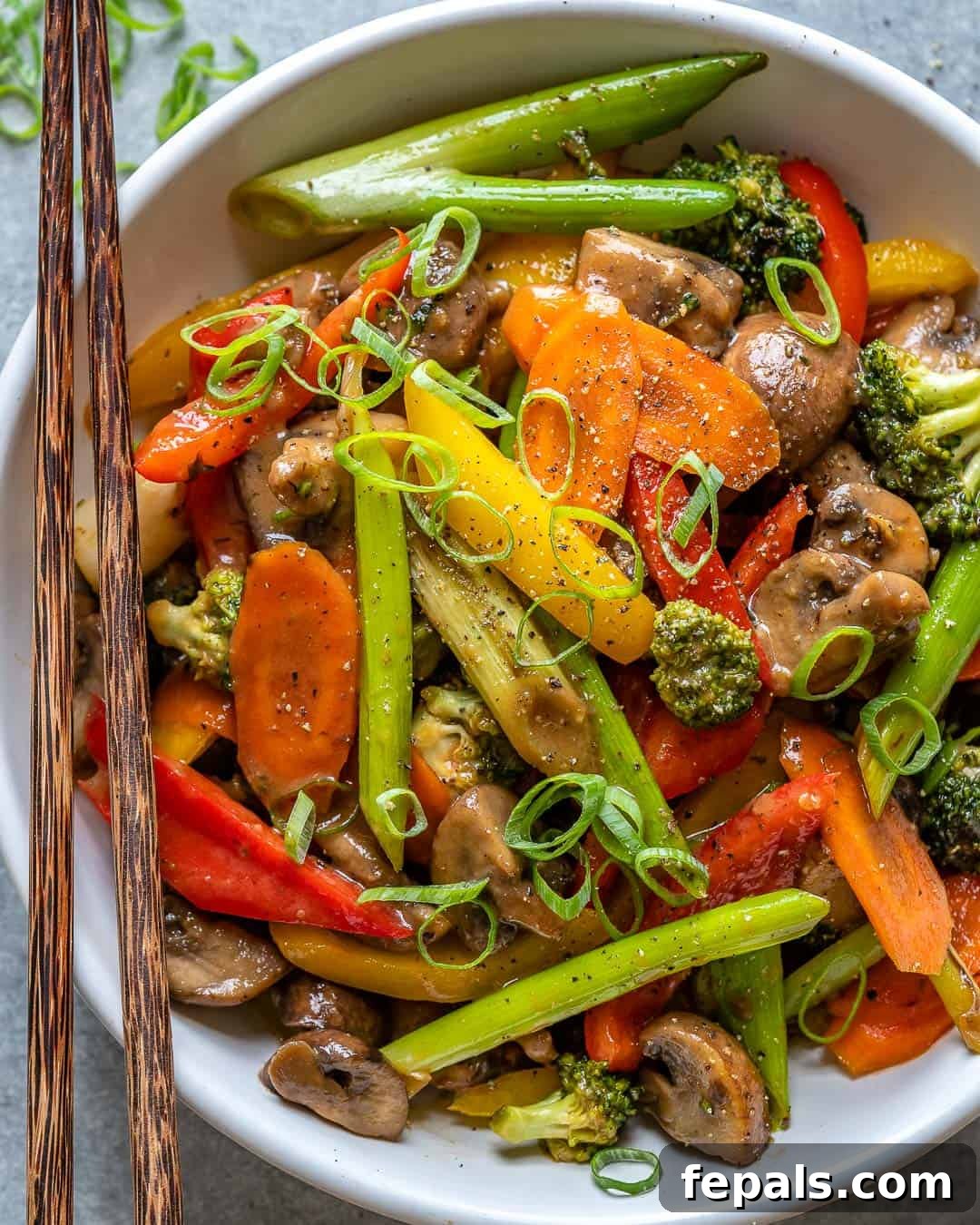 Vibrant Sweet and Sour Vegetable Stir-Fry 8 Sweet and sour vegetable stir fry in a white bowl with chopsticks, presented beautifully.