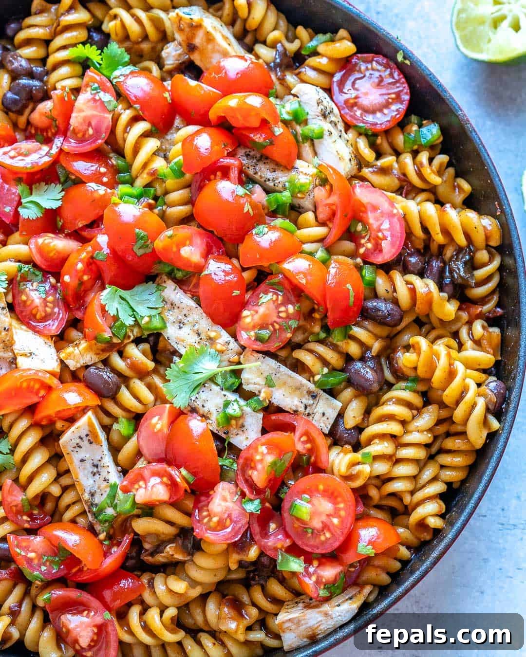Smoky Chipotle Chicken Pasta 7 Partial pot of Mexican Chipotle Pasta with tomatoes and cilantro on top