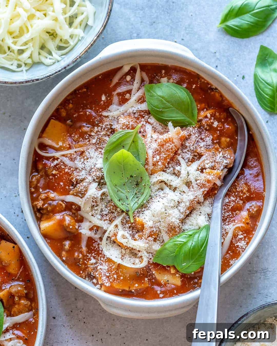 Comforting One Pot Lasagna Soup 2 lasagna soup in white bowl with spoon in it