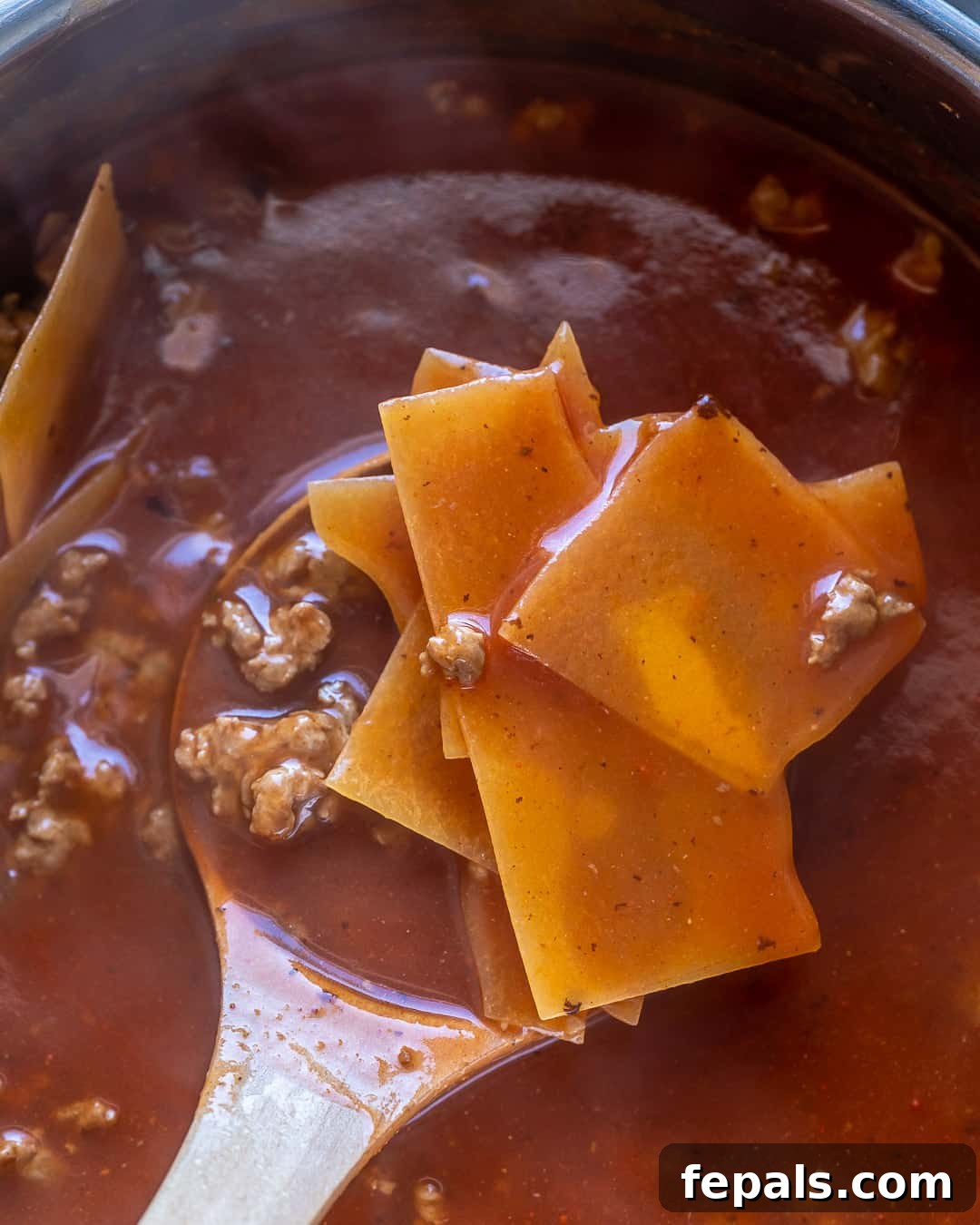 Comforting One Pot Lasagna Soup 5 Pasta noodles in soup before fully cooked.