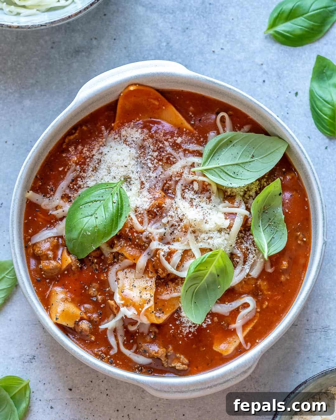 Comforting One Pot Lasagna Soup 8 One bowl of one pot lasagna soup with basil and cheese