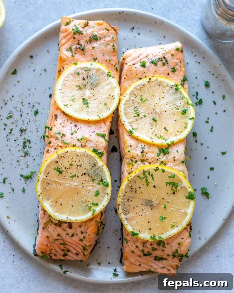 top view salmon with sliced lemon garnishes