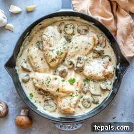 Top view of mushroom chicken in a blue skillet, ready to be served.