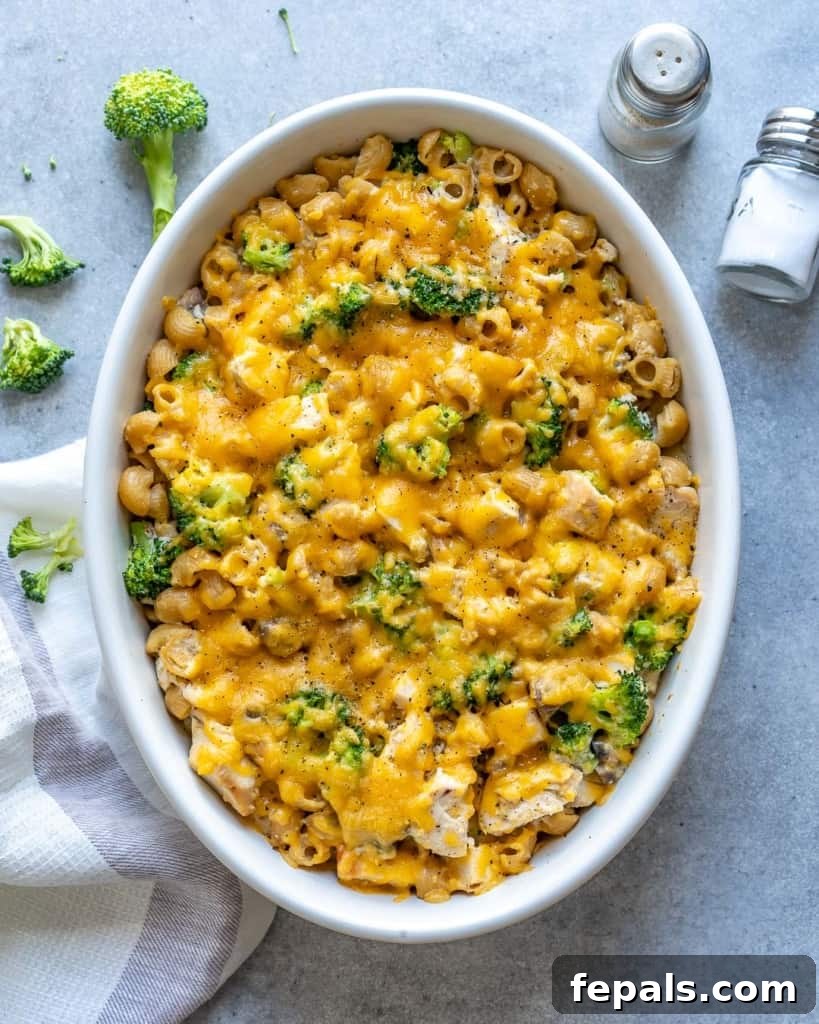 A golden-brown Broccoli Chicken Pasta Casserole in a white dish, ready to be served.