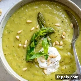 top view of spoon in asparagus soup