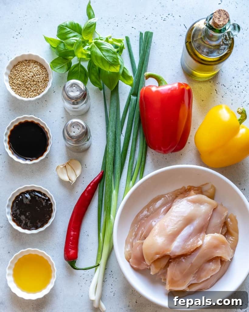 Collection of fresh ingredients for Thai basil chicken recipe, including chicken, basil, bell peppers, and sauces.