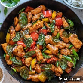 top view of basil chicken recipe in black skillet