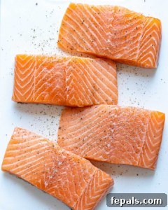 Four salmon filets seasoned with salt and pepper
